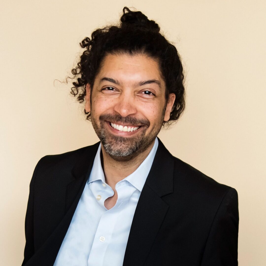 Man with curly hair smiling
