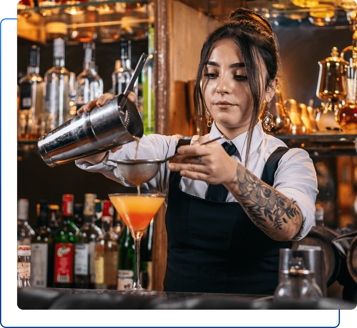 Bartender mixing a cocktail at bar