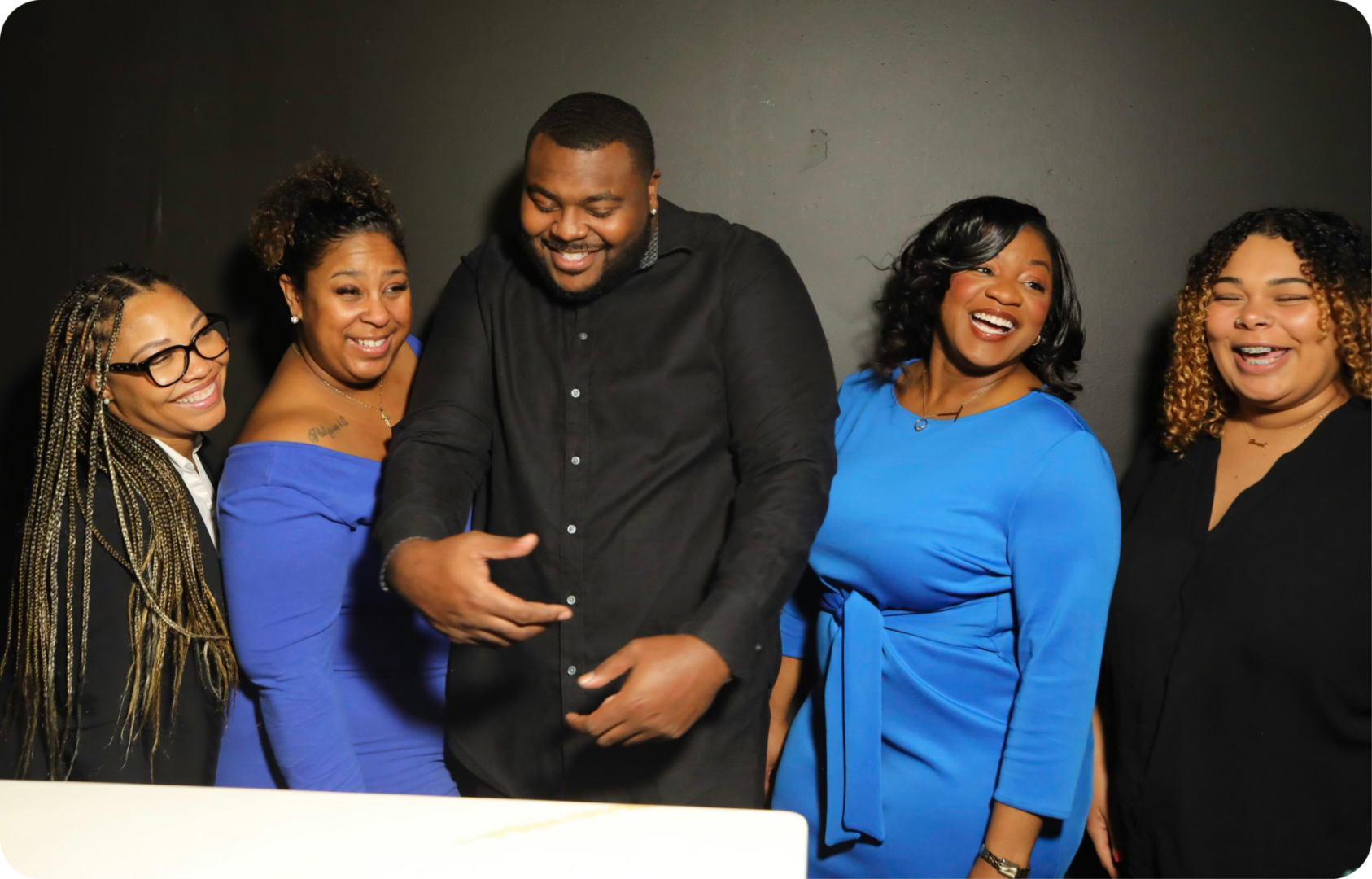 Five adults smiling and laughing together