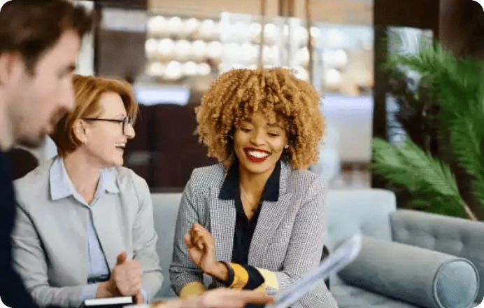 Smiling colleagues chatting in modern office lounge