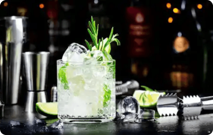 Iced lime cocktail garnished with rosemary